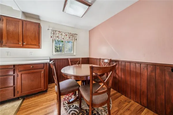 a view of a dining room with furniture and wooden floor