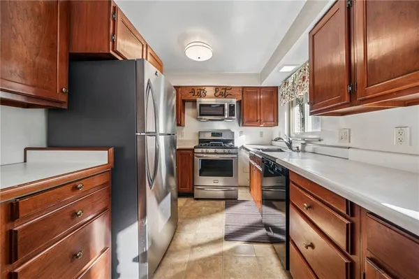 a kitchen with stainless steel appliances granite countertop a refrigerator and a stove top oven