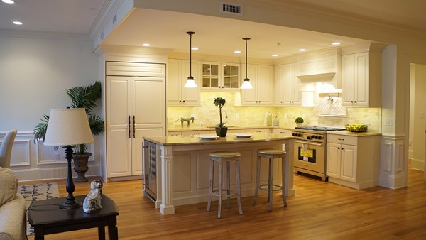 447 Beacon Street, Unit 3 Boston, MA 02115 - Photo 7 of 7 a kitchen with stainless steel appliances kitchen island granite countertop a table chairs sink and cabinets