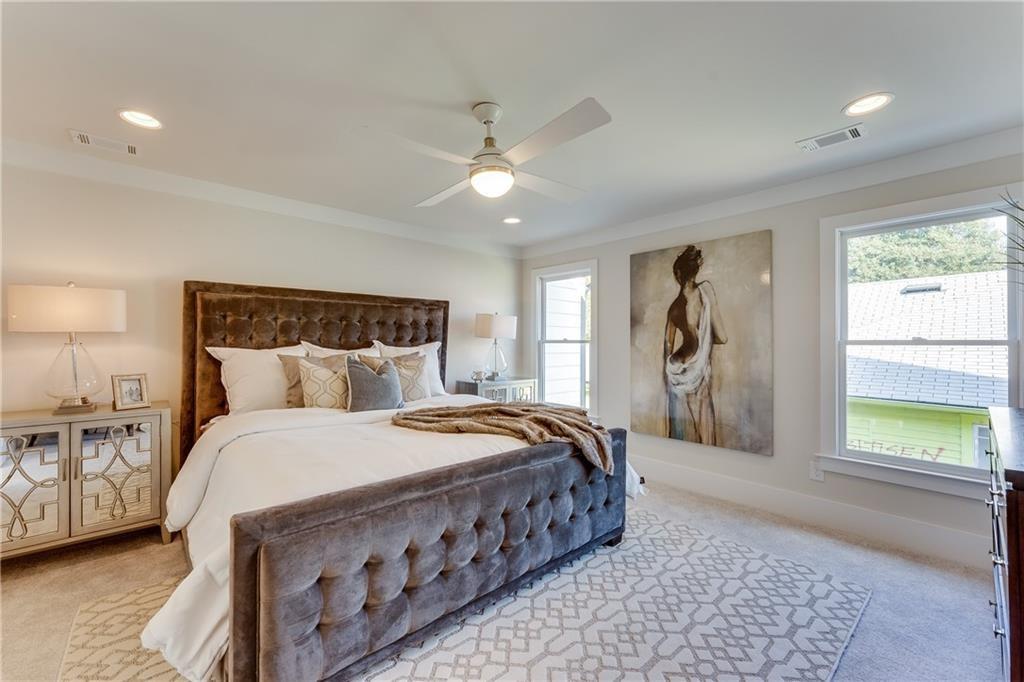 76 Mayson Avenue Northeast, Unit B Atlanta, GA 30307 - Photo 14 of 40 a bedroom with a large bed and a chandelier