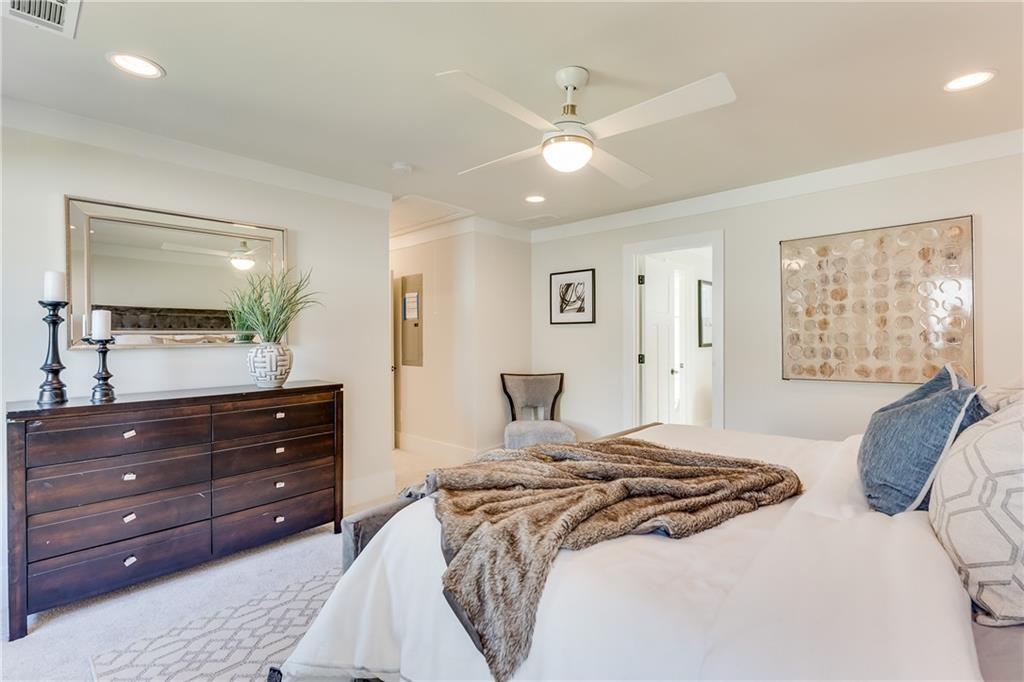 76 Mayson Avenue Northeast, Unit B Atlanta, GA 30307 - Photo 16 of 40 a bedroom with a bed and a mirror on dresser