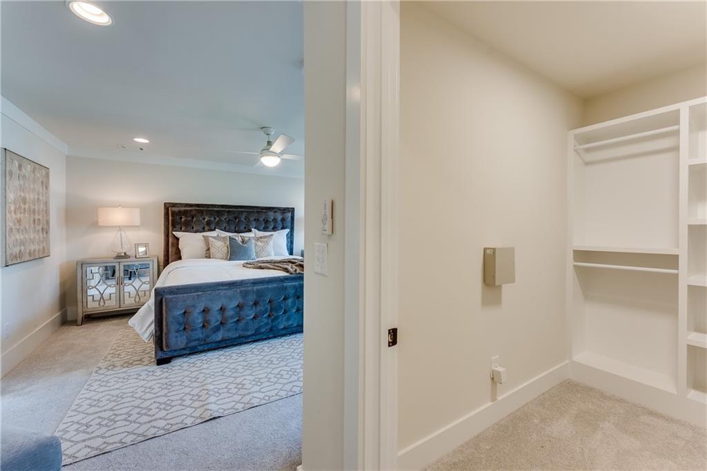 76 Mayson Avenue Northeast, Unit B Atlanta, GA 30307 - Photo 17 of 40 a bedroom with a large bed and wooden floor