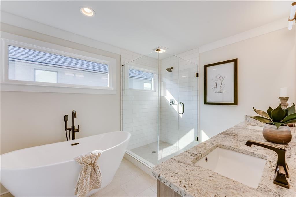 76 Mayson Avenue Northeast, Unit B Atlanta, GA 30307 - Photo 19 of 40 a bathroom with a granite countertop sink and a bathtub