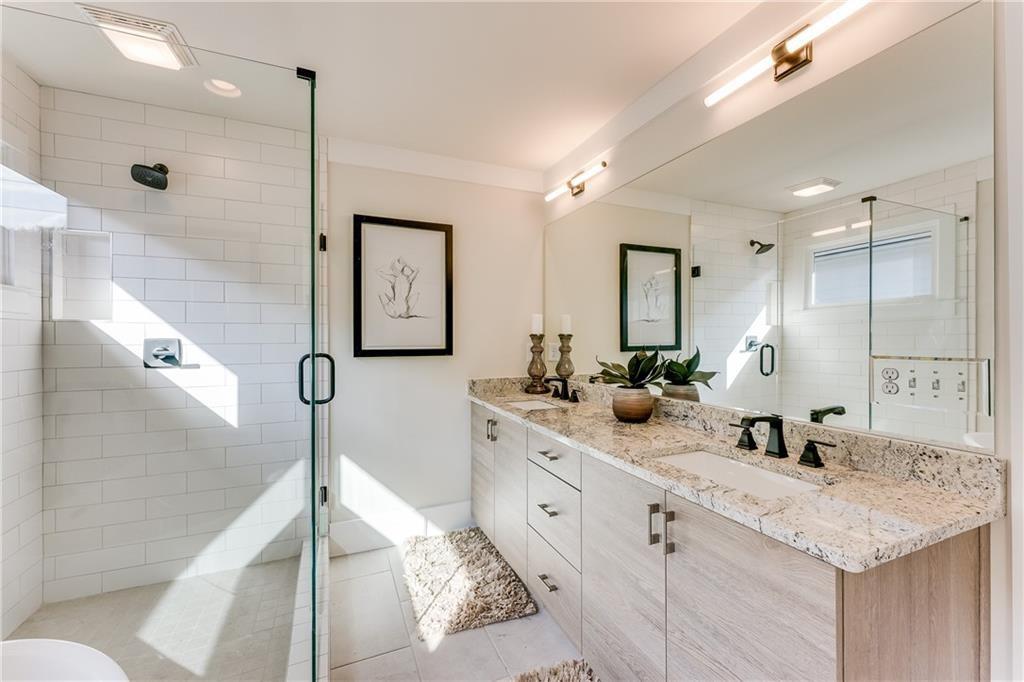 76 Mayson Avenue Northeast, Unit B Atlanta, GA 30307 - Photo 21 of 40 a bathroom with double vanity sink and a mirror
