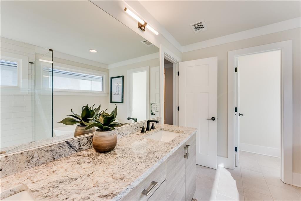 76 Mayson Avenue Northeast, Unit B Atlanta, GA 30307 - Photo 22 of 40 a bathroom with a granite countertop sink and a mirror
