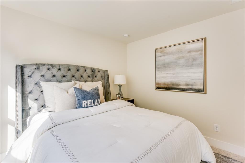 76 Mayson Avenue Northeast, Unit B Atlanta, GA 30307 - Photo 24 of 40 a bedroom with a bed and a painting on the wall