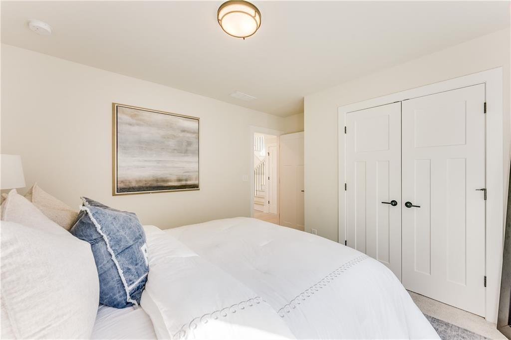 76 Mayson Avenue Northeast, Unit B Atlanta, GA 30307 - Photo 25 of 40 a bedroom with a bed and a painting on the wall