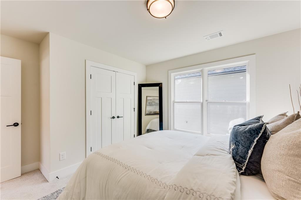 76 Mayson Avenue Northeast, Unit B Atlanta, GA 30307 - Photo 26 of 40 a bedroom with a bed and a closet