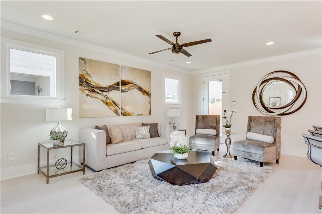 76 Mayson Avenue Northeast, Unit B Atlanta, GA 30307 - Photo 5 of 40 a living room with furniture and a clock