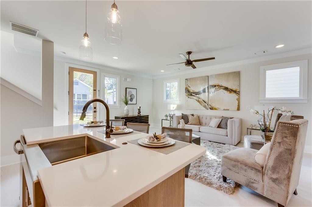 76 Mayson Avenue Northeast, Unit B Atlanta, GA 30307 - Photo 6 of 40 a kitchen with stainless steel appliances granite countertop a sink a stove and a refrigerator