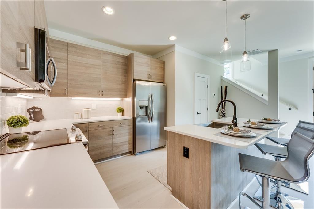 76 Mayson Avenue Northeast, Unit B Atlanta, GA 30307 - Photo 7 of 40 a kitchen with stainless steel appliances granite countertop a sink stove and refrigerator