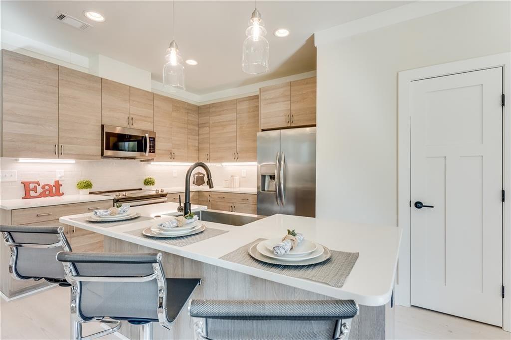 76 Mayson Avenue Northeast, Unit B Atlanta, GA 30307 - Photo 8 of 40 a kitchen with dining table and chairs