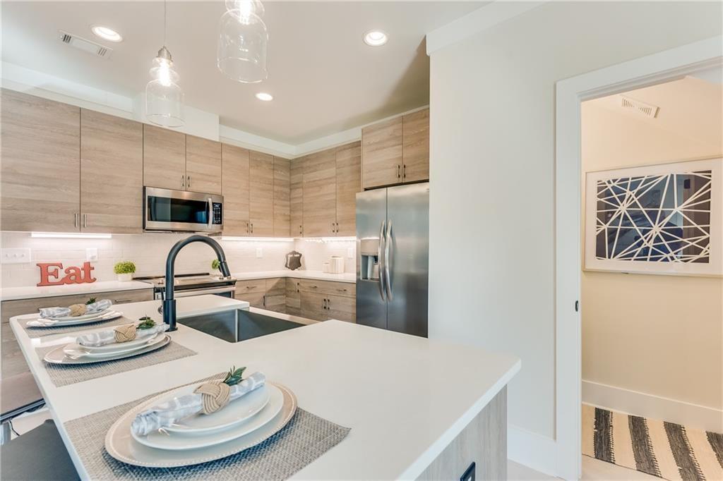 76 Mayson Avenue Northeast, Unit B Atlanta, GA 30307 - Photo 10 of 40 a kitchen with stainless steel appliances granite countertop a sink a stove and a refrigerator