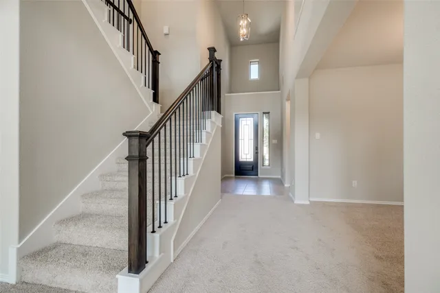 a view of a hallway with wooden floor and entryway