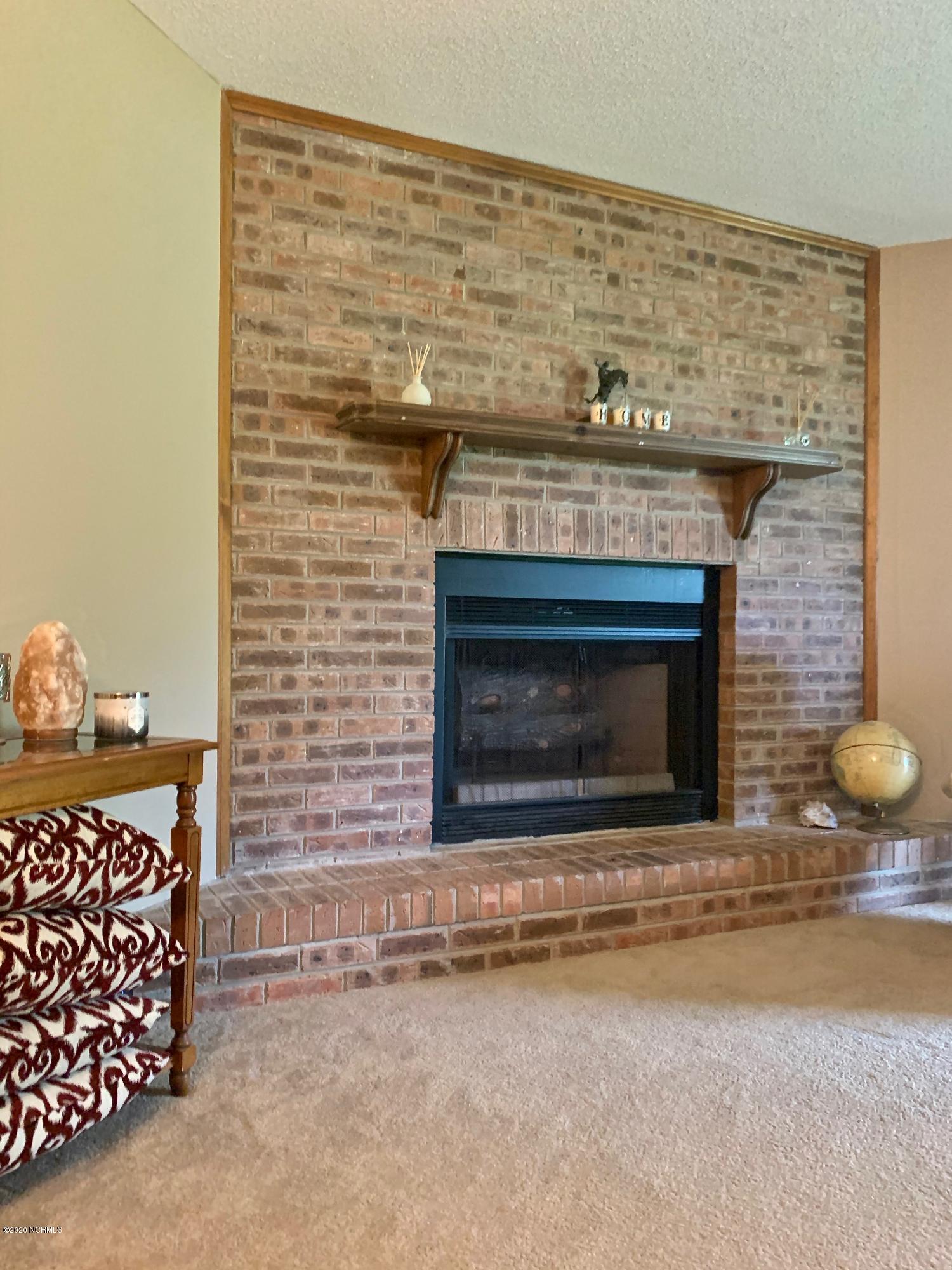 5036 Mill Branch Road Northwest Ash, NC 28420 - Photo 15 of 31 Beautiful brick gas fireplace. Gas heating system new 2019 and water heater.