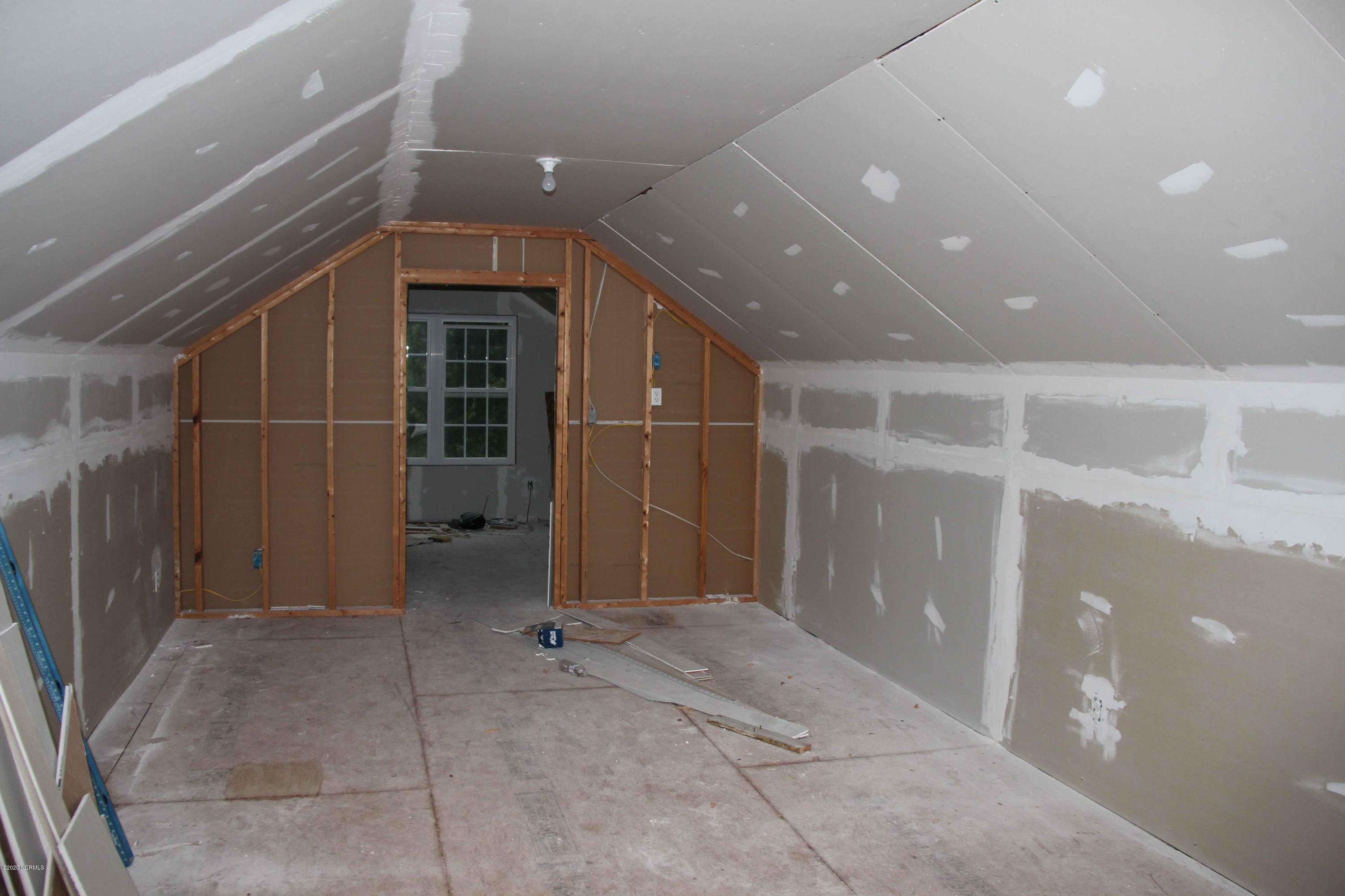5036 Mill Branch Road Northwest Ash, NC 28420 - Photo 7 of 31 Garage is unfinished upstairs and has many possibilities, rental apt, guest quarters etc.