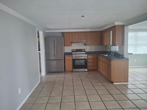 3538 Garfield Drive Holiday, FL 34691 - Photo 10 of 16 a kitchen with stainless steel appliances granite countertop a stove a sink and a refrigerator