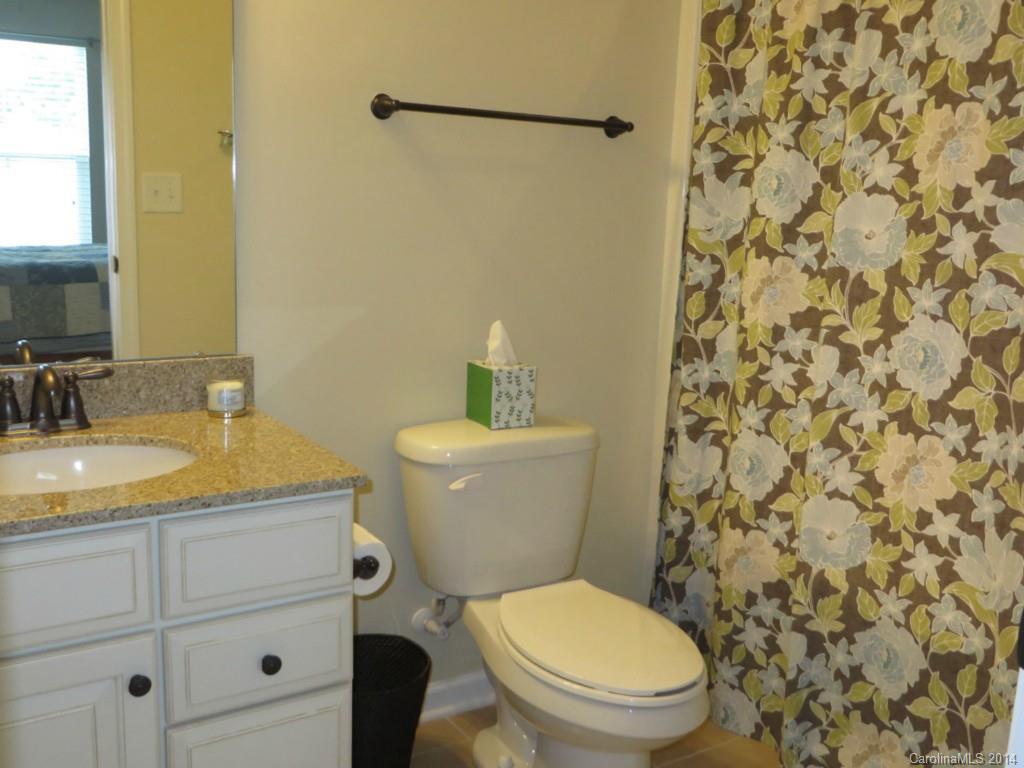 3005 Fallondale Road Waxhaw, NC 28173 - Photo 17 of 20 a bathroom with a granite countertop toilet a sink and a mirror