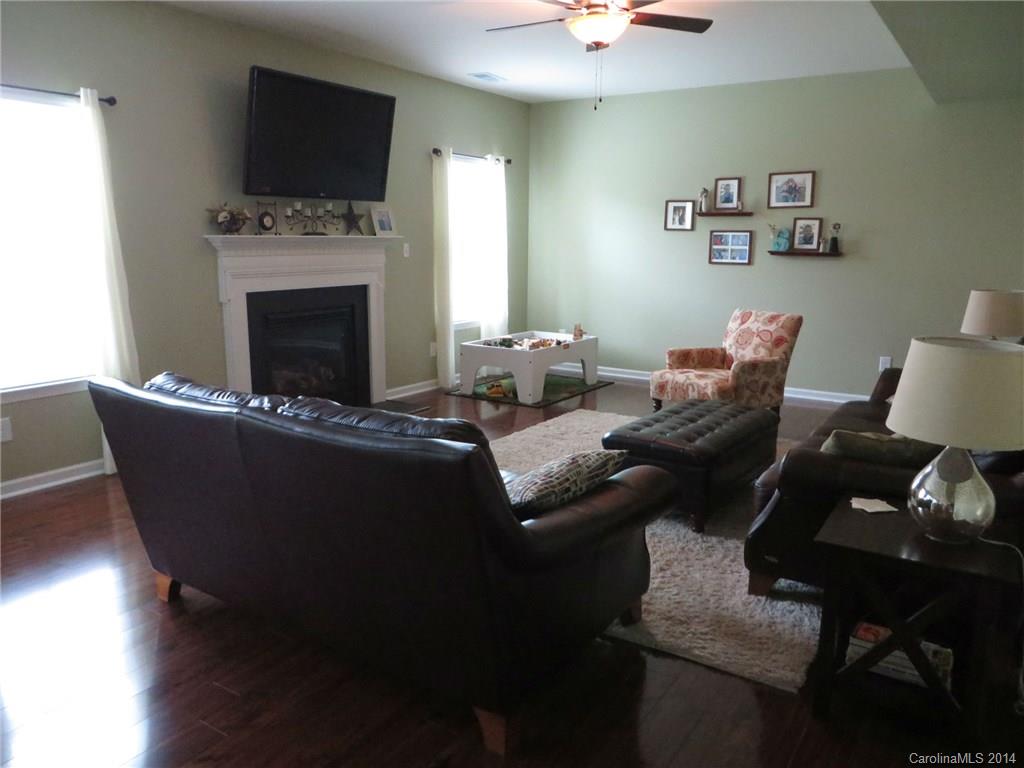 3005 Fallondale Road Waxhaw, NC 28173 - Photo 6 of 20 a living room with furniture a fireplace and a flat screen tv