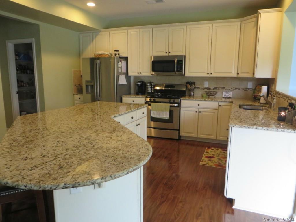 3005 Fallondale Road Waxhaw, NC 28173 - Photo 9 of 20 a kitchen with stainless steel appliances granite countertop a sink stove and refrigerator