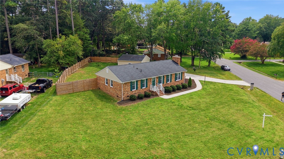 3221 Clintwood Road Midlothian, VA 23112 - Photo 45 of 46 Brick facade with green shutters, a dark shingle r