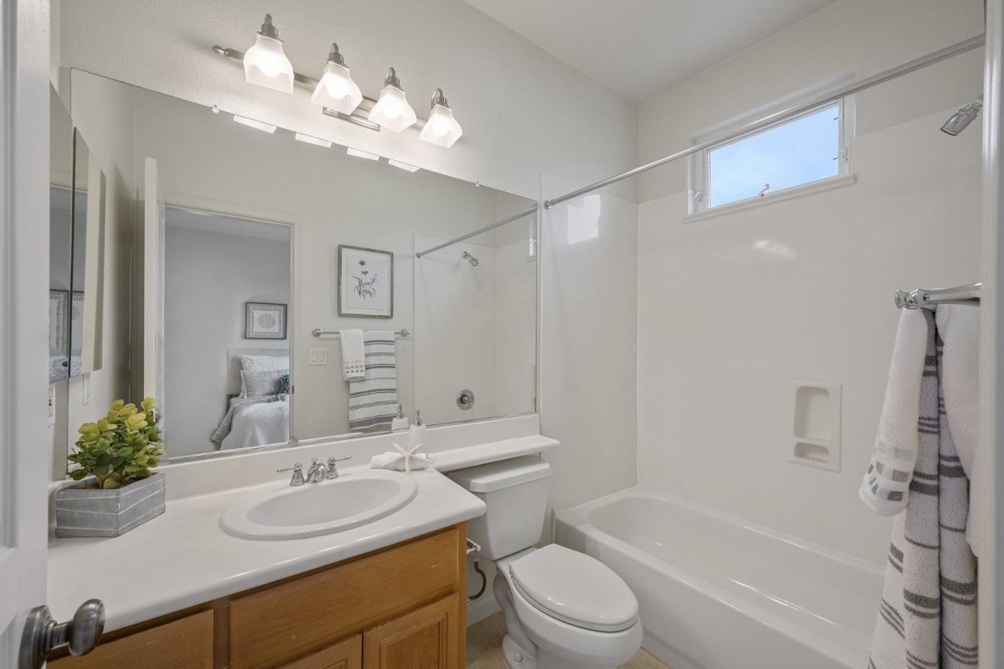 4517 Lick Mill Boulevard Santa Clara, CA 95054 - Photo 27 of 38 a bathroom with a granite countertop sink a toilet and a mirror