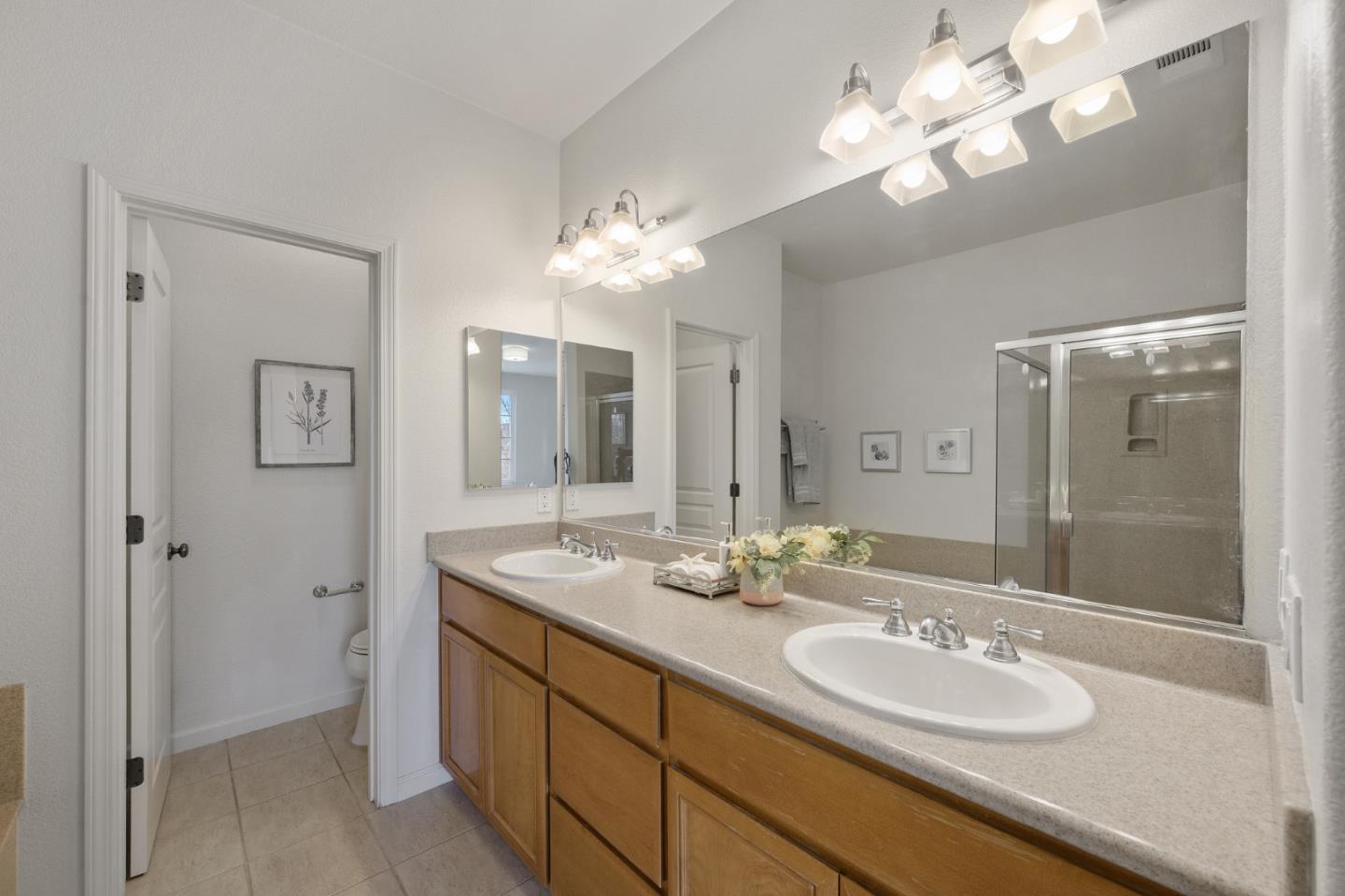 4517 Lick Mill Boulevard Santa Clara, CA 95054 - Photo 32 of 38 a spacious bathroom with double vanity sinks a toilet a shower a vanity and a mirror