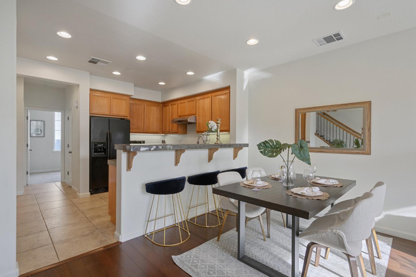4517 Lick Mill Boulevard Santa Clara, CA 95054 - Photo 10 of 38 a kitchen with a dining table cabinets and refrigerator