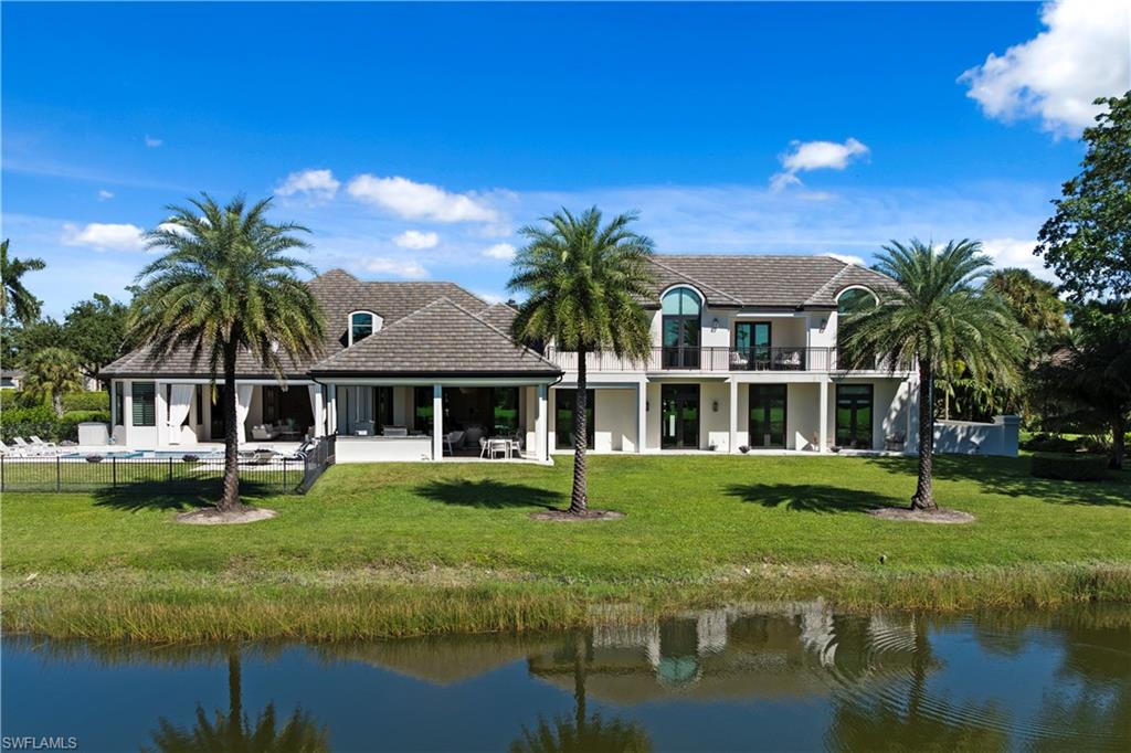 a front view of a house with garden and swimming pool