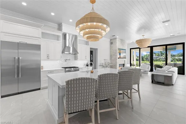 an open kitchen with dining table and chairs