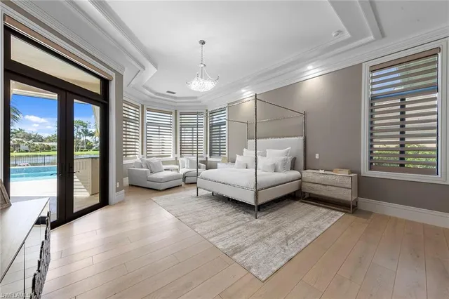 a bedroom with furniture and a large window