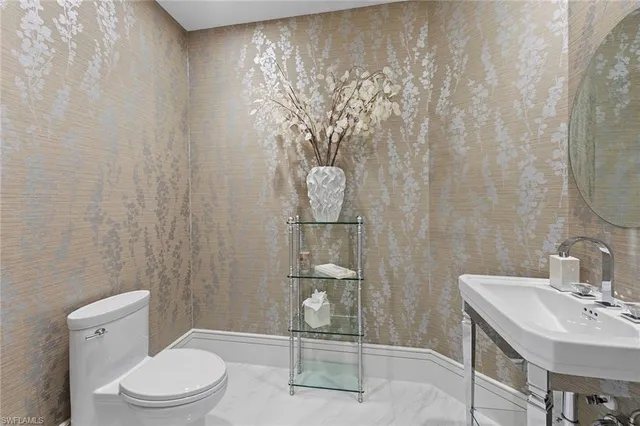 a bathroom with a toilet a sink and garden