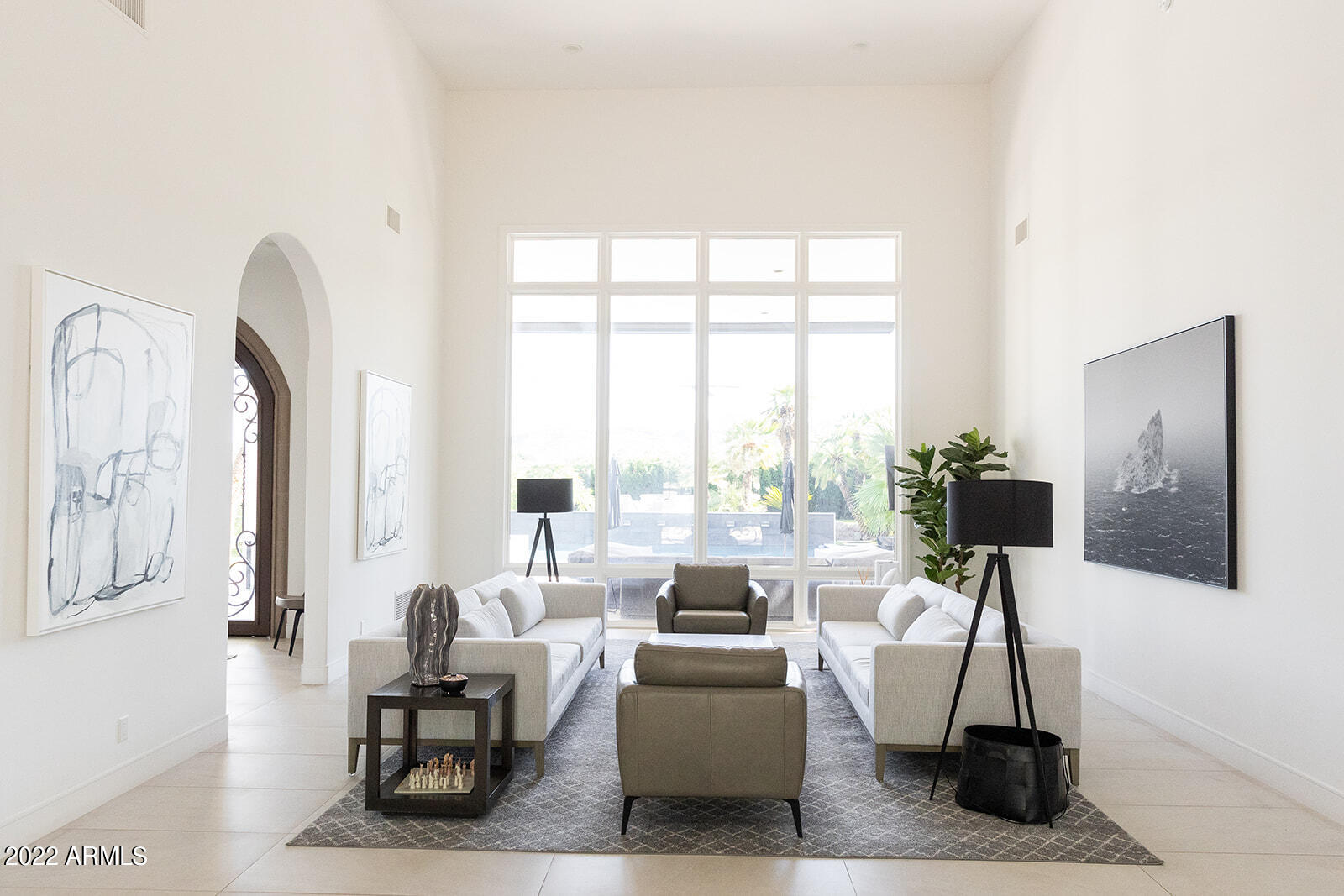 6271 East Horseshoe Road Paradise Valley, AZ 85253 - Photo 1 of 16 a living room with furniture a large window and a flat screen tv