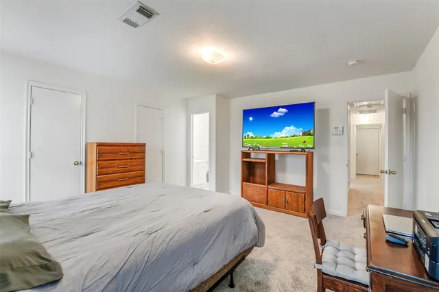 a bedroom with a bed and a television