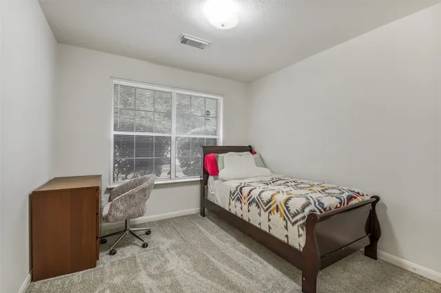 a bedroom with a bed and a window