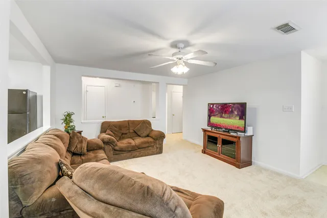 a living room with furniture a couch and a flat screen tv