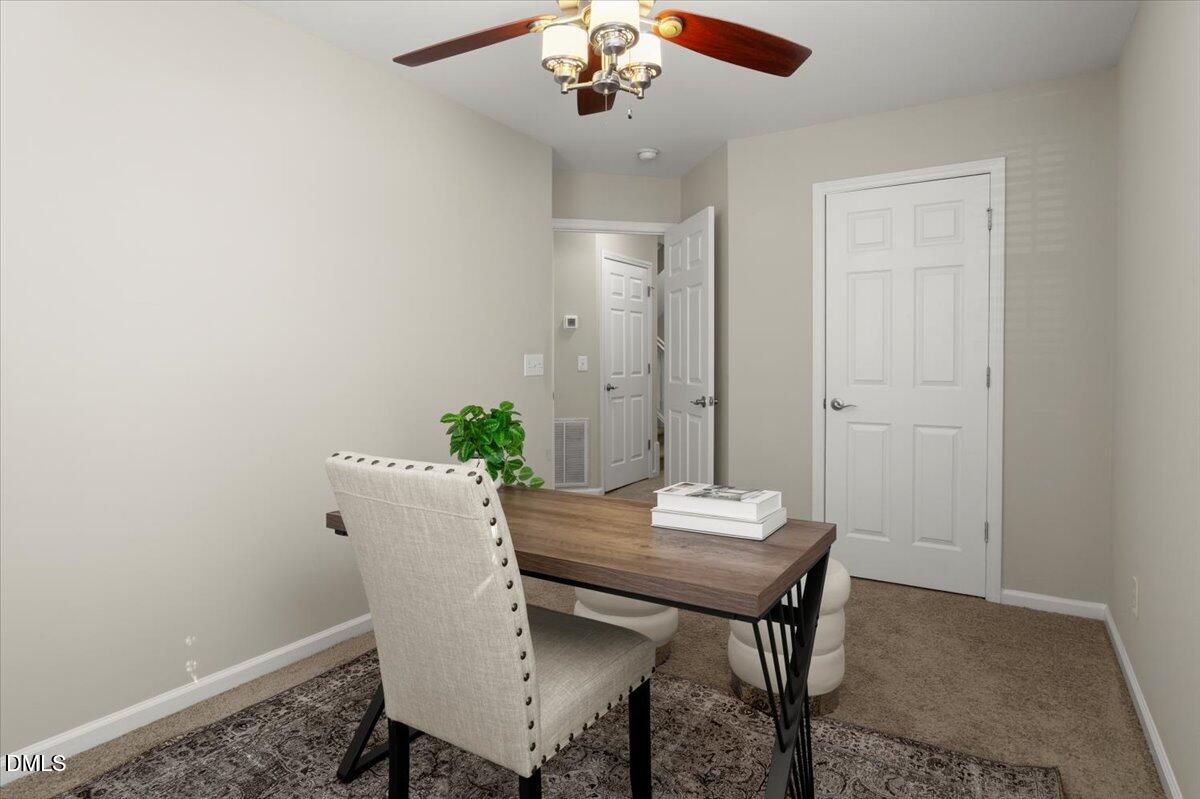 2920 Barrymore Street, Unit 106 Raleigh, NC 27603 - Photo 12 of 31 a view of a dining room with furniture and wooden floor