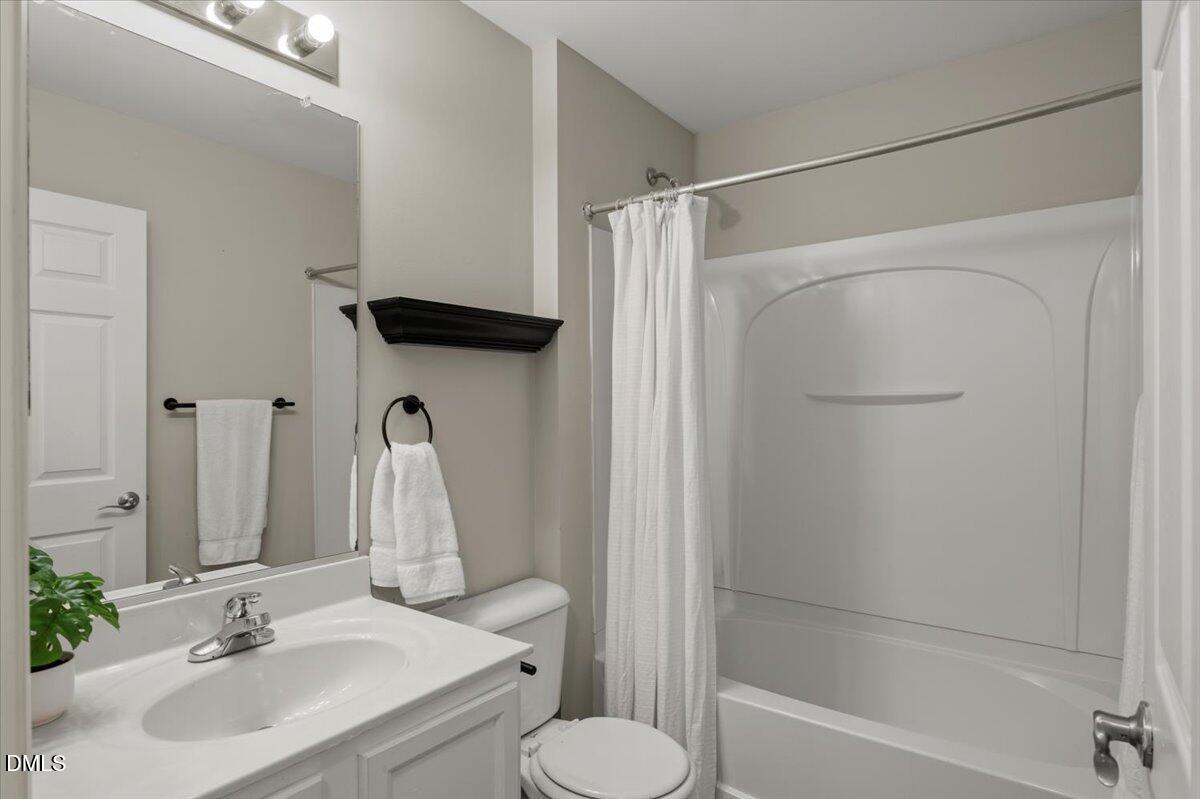 2920 Barrymore Street, Unit 106 Raleigh, NC 27603 - Photo 16 of 31 a bathroom with a sink toilet and shower