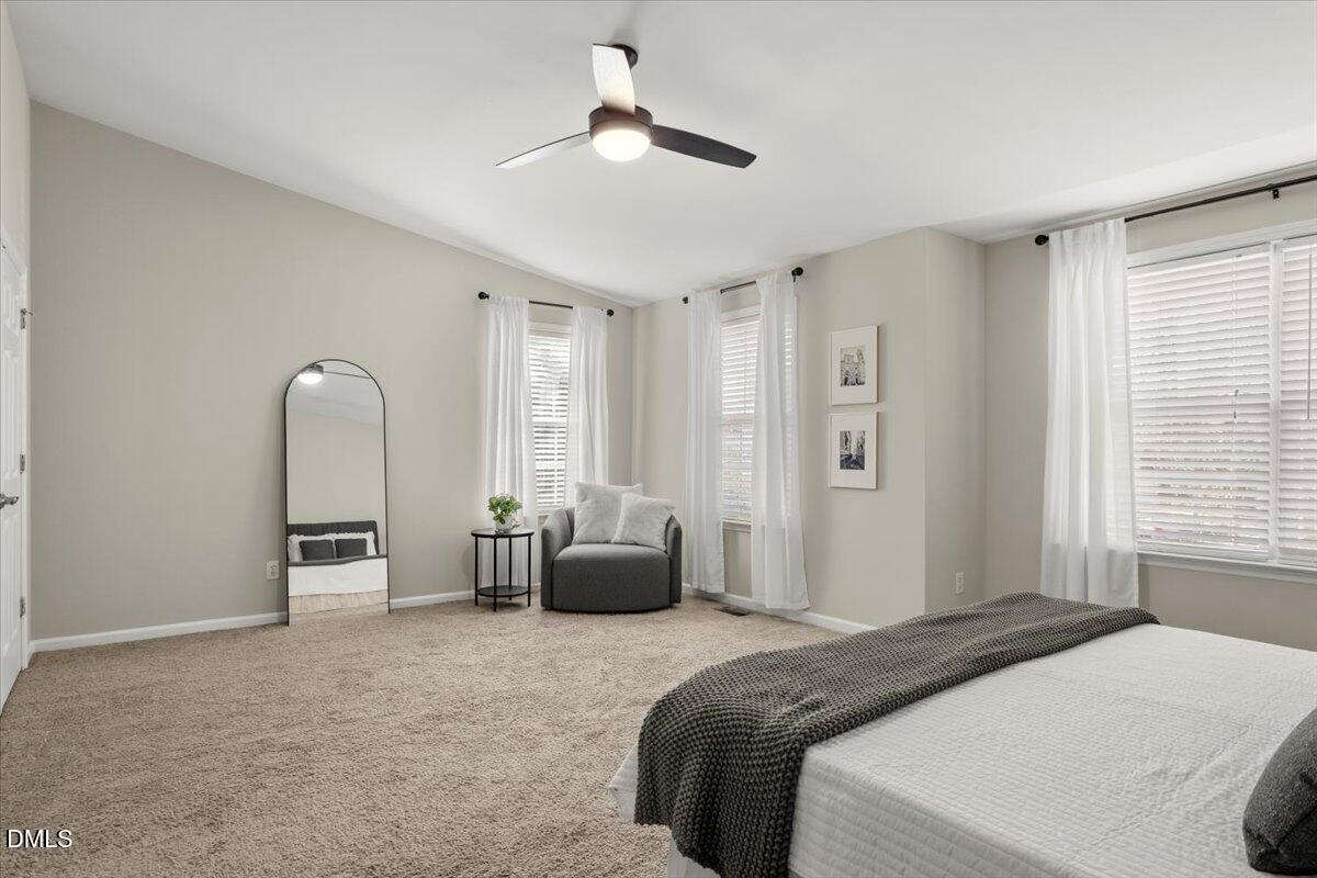 2920 Barrymore Street, Unit 106 Raleigh, NC 27603 - Photo 17 of 31 a bedroom with a bed large window and couch