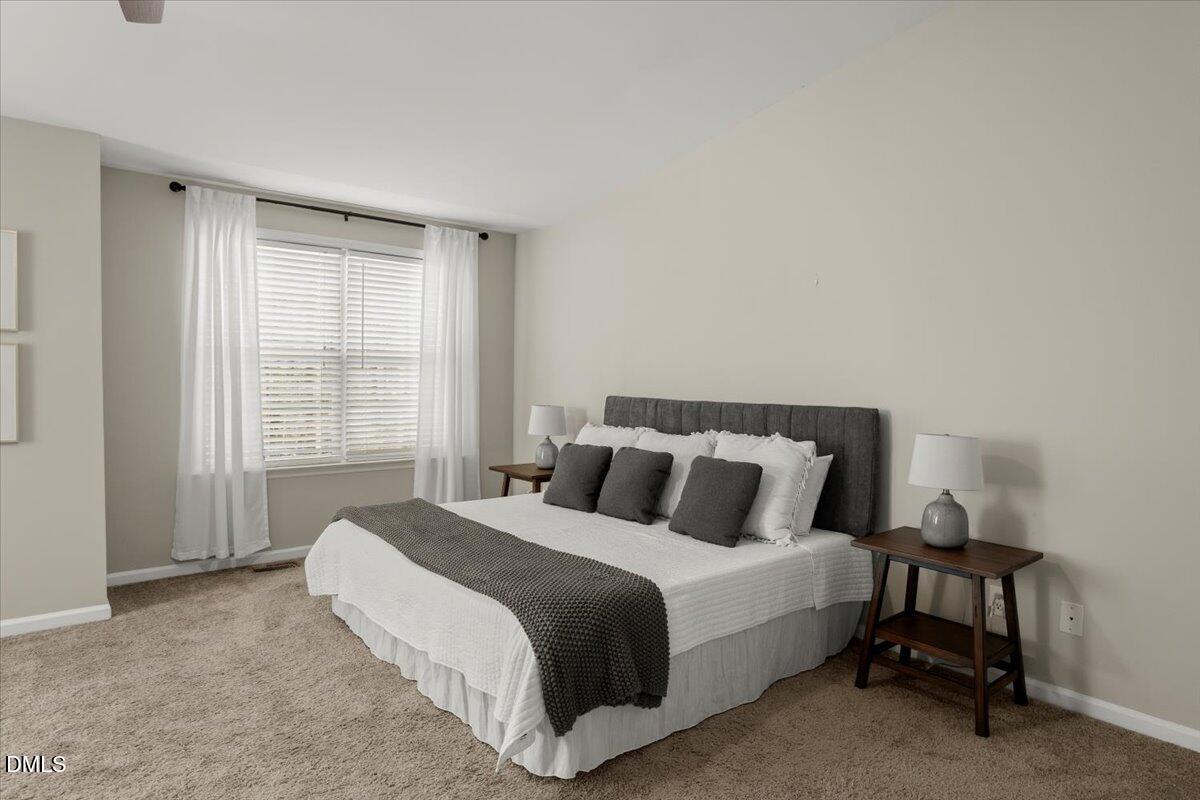 2920 Barrymore Street, Unit 106 Raleigh, NC 27603 - Photo 18 of 31 a bedroom with a bed and a window