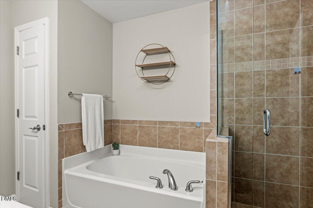 2920 Barrymore Street, Unit 106 Raleigh, NC 27603 - Photo 22 of 31 a bathroom with a bathtub