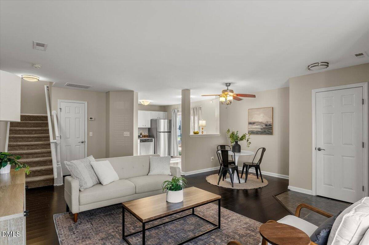 2920 Barrymore Street, Unit 106 Raleigh, NC 27603 - Photo 4 of 31 a living room with furniture potted plant and kitchen view