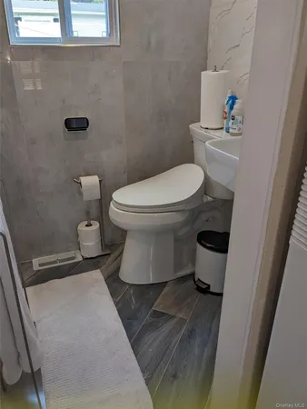a white toilet sitting next to a white sink