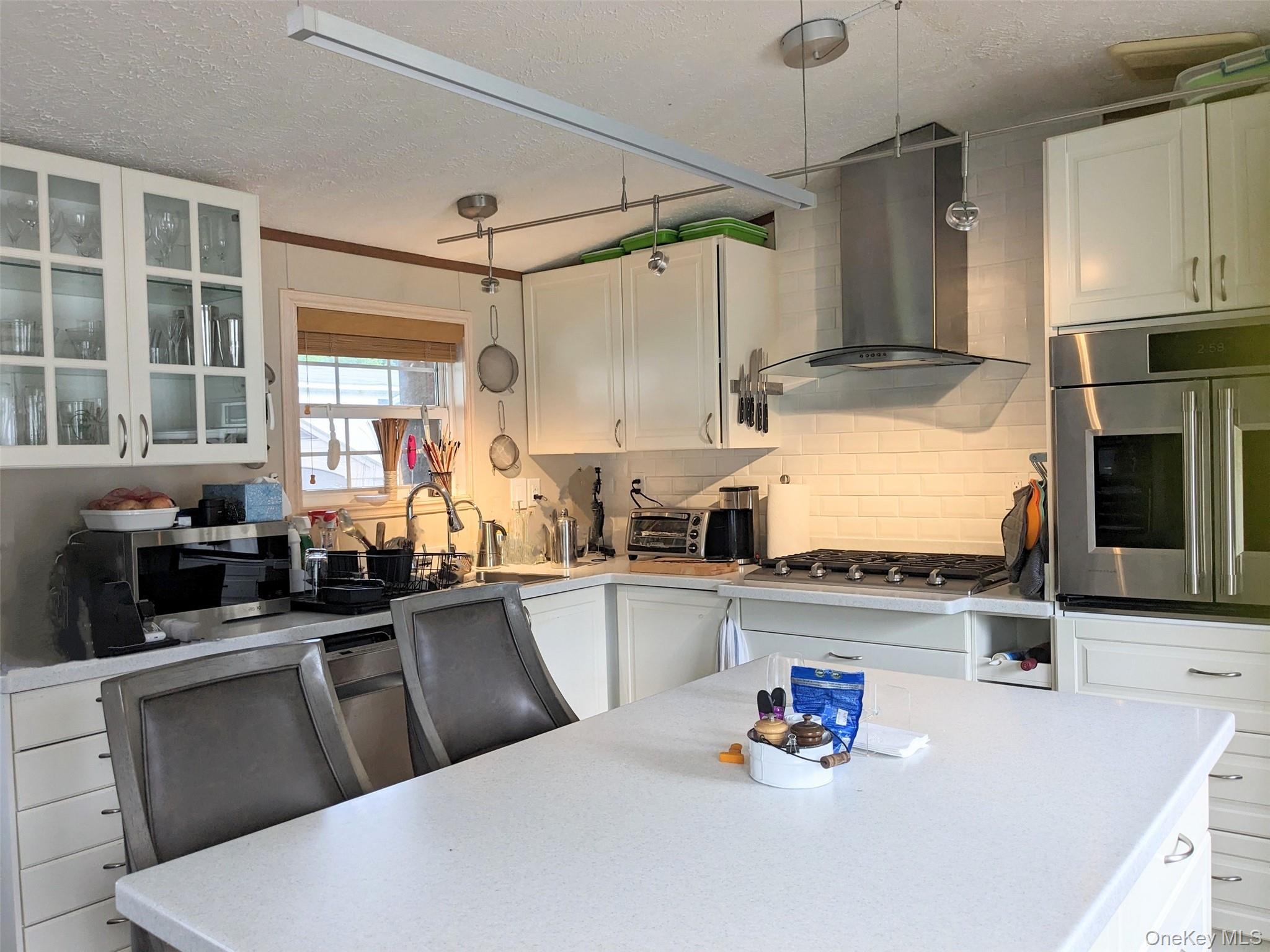 4 Treeline Circle, Unit 4 Cold Spring, NY 10516 - Photo 15 of 16 a kitchen with granite countertop a sink stainless steel appliances and cabinets