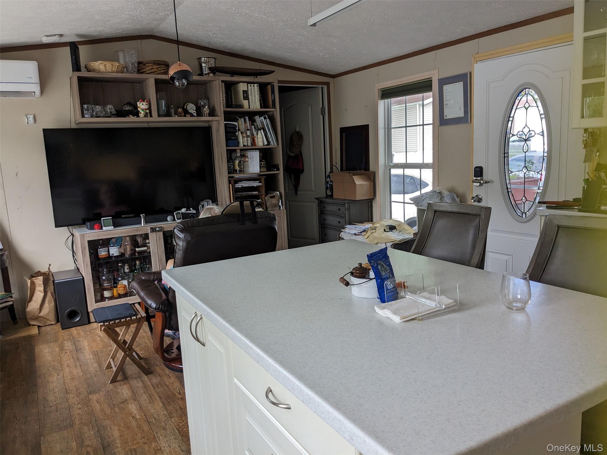 4 Treeline Circle, Unit 4 Cold Spring, NY 10516 - Photo 6 of 16 a kitchen with a table chairs and a flat screen tv