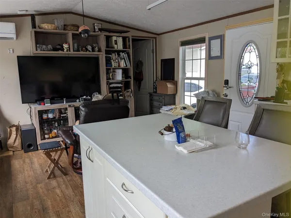a kitchen with a table chairs and a flat screen tv