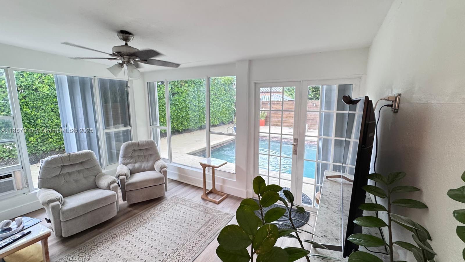 3911 Southwest 61st Avenue Miami, FL 33155 - Photo 16 of 38 a living room with furniture a ceiling fan and a large window