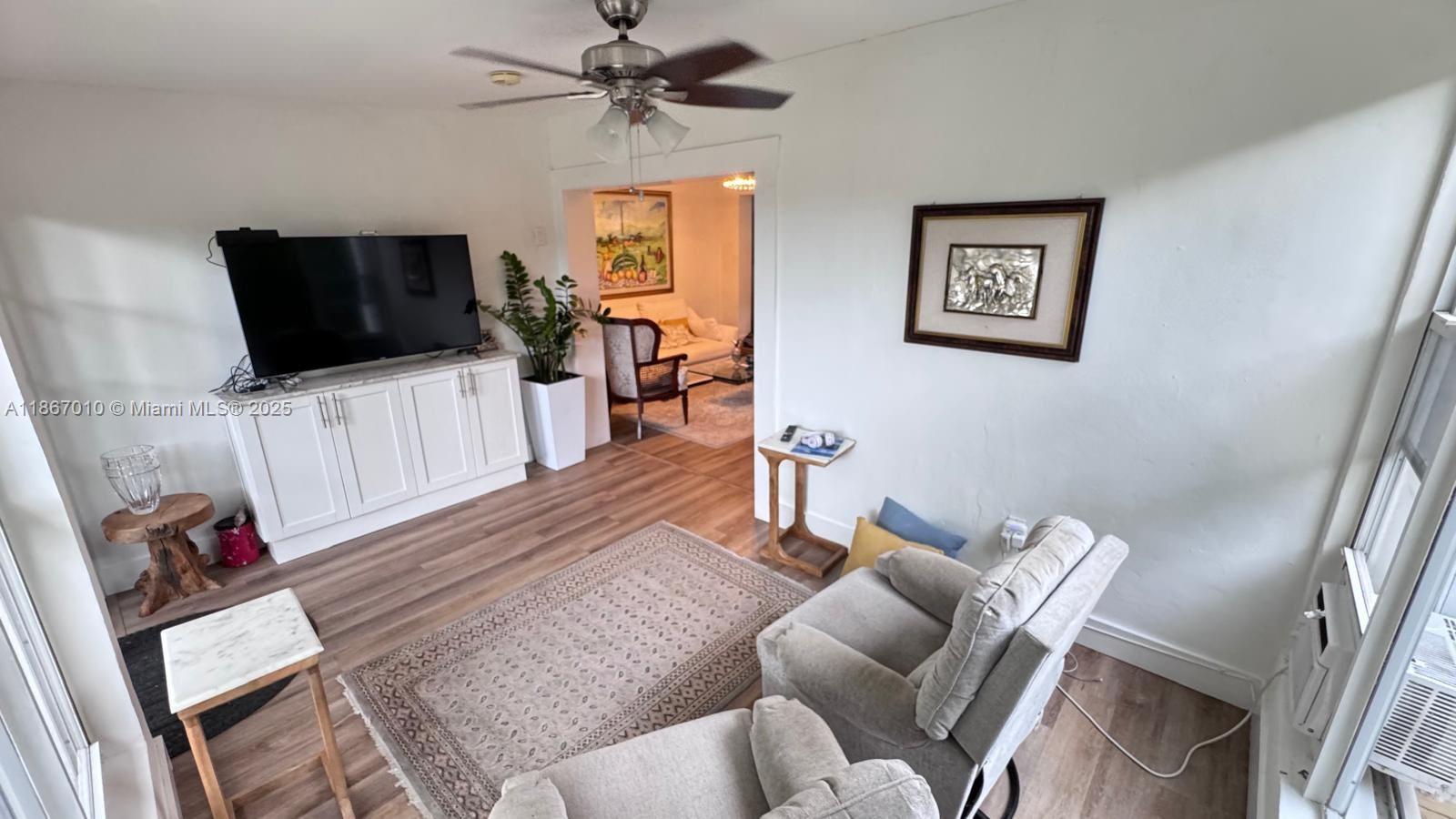 3911 Southwest 61st Avenue Miami, FL 33155 - Photo 22 of 38 a living room with furniture and a flat screen tv