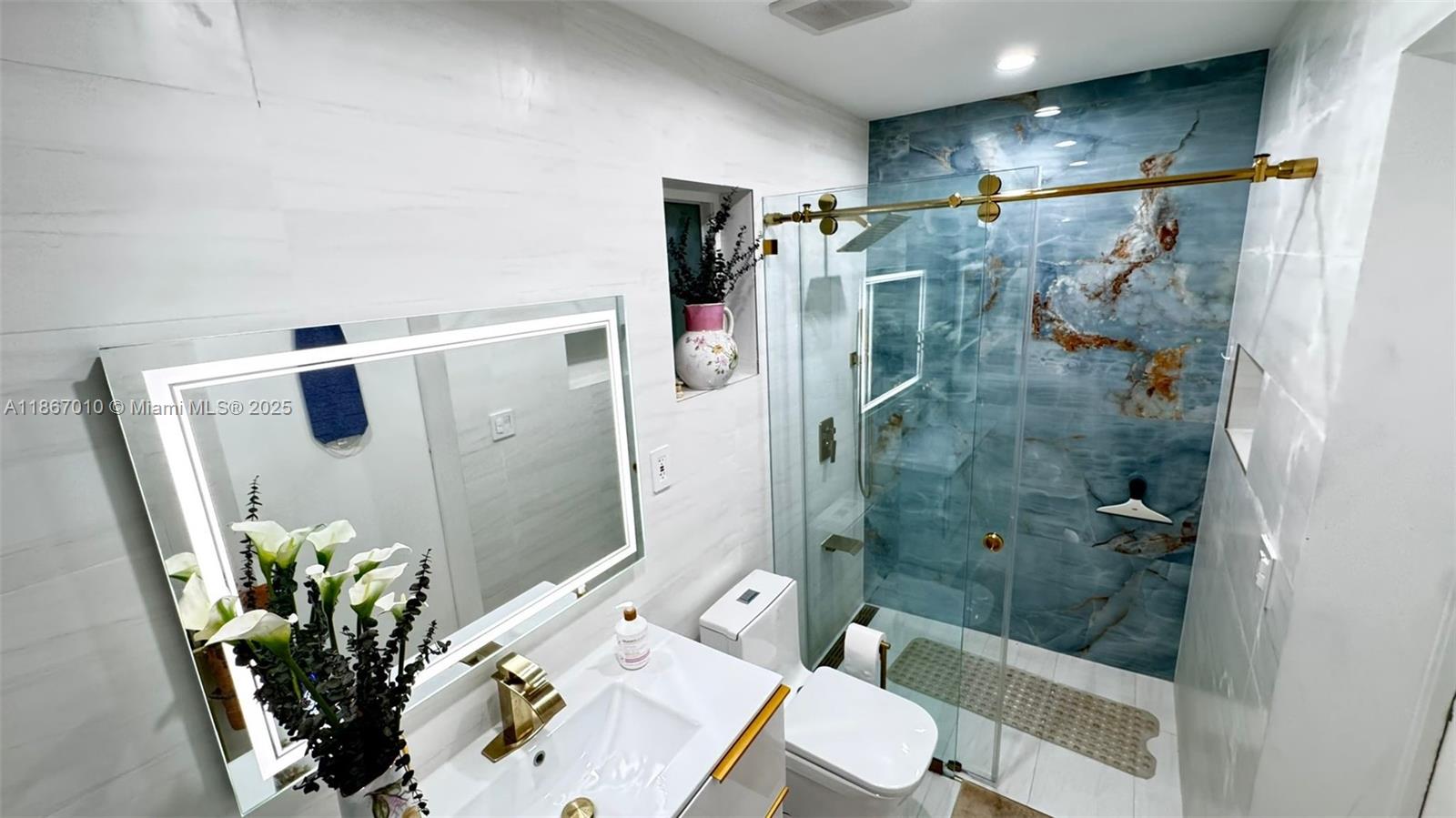 3911 Southwest 61st Avenue Miami, FL 33155 - Photo 27 of 38 a bathroom with a shower and a mirror