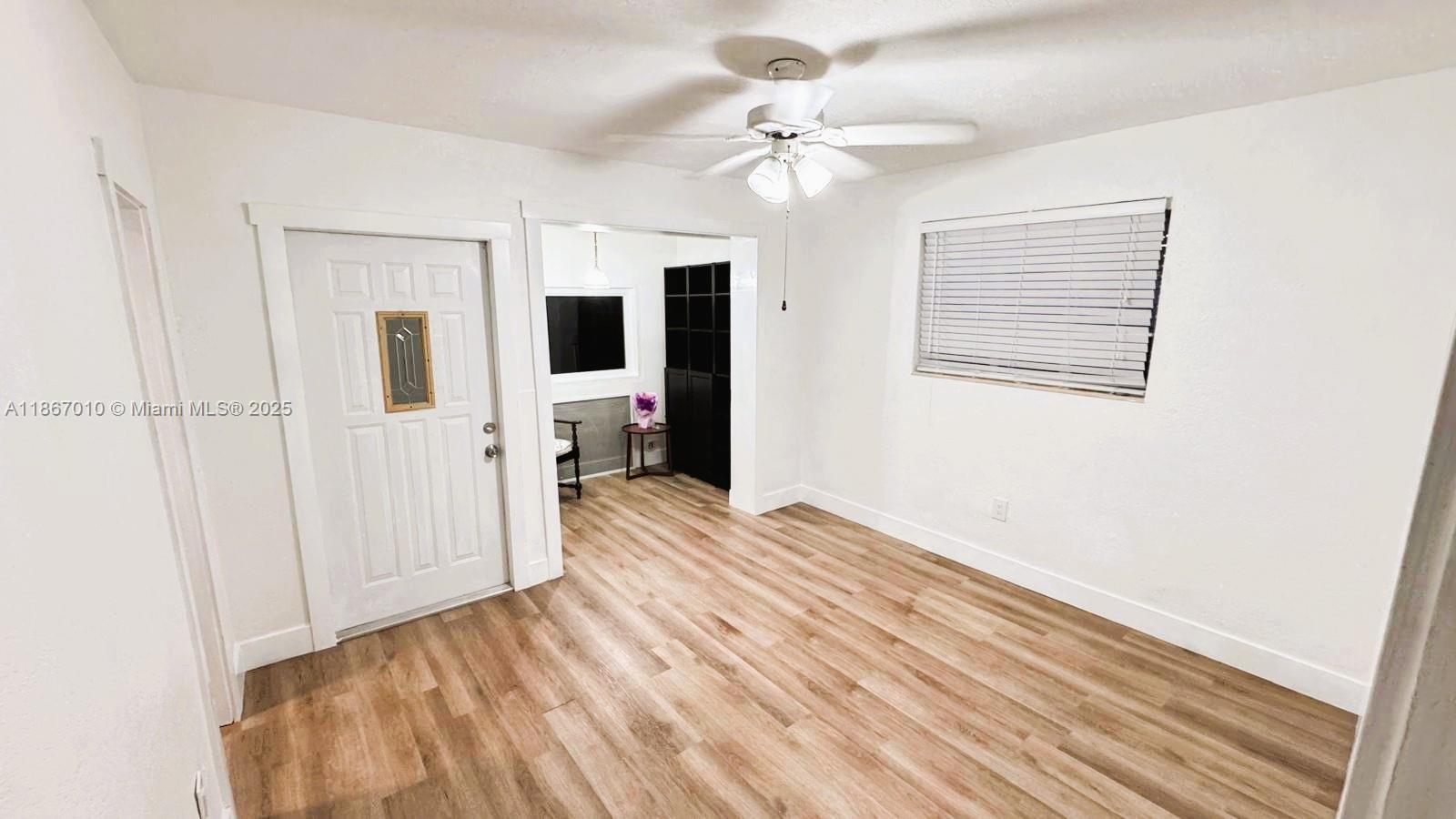3911 Southwest 61st Avenue Miami, FL 33155 - Photo 29 of 38 wooden floor in an empty room with a window